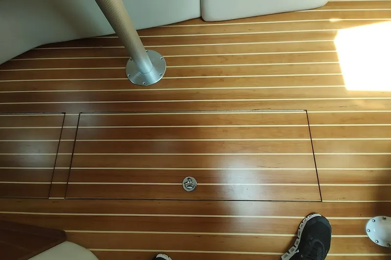 Slide: The Image of Wooden deck of 2006 Regal Commodore 3560 IO boat with hatch and metal pole. - 32