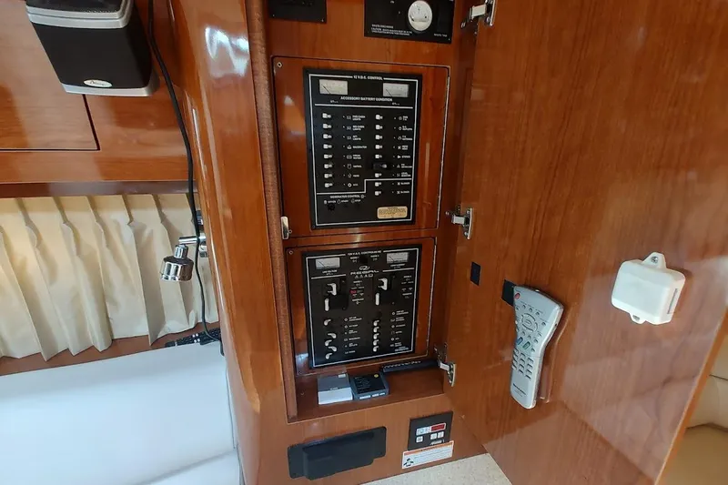 Slide: The Image of Control panel inside 2006 Regal Commodore 3560 IO yacht, featuring switches and remote. - 34