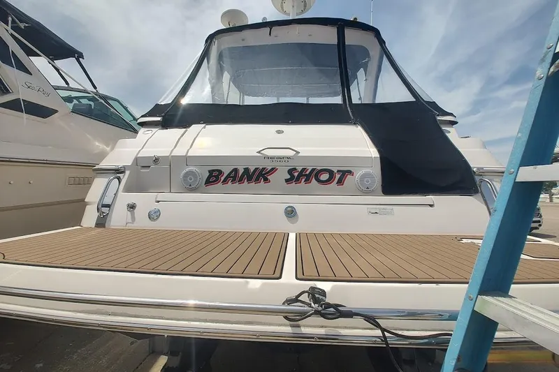 Slide: The Image of 2006 Regal Commodore 3560 IO boat with "Bank Shot" name, docked at marina. - 6