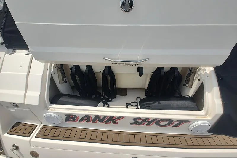 Slide: The Image of 2006 Regal Commodore 3560 IO boat with open storage compartment labeled "Bank Shot." - 7