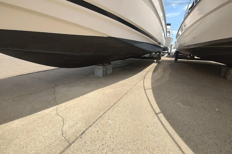 Slide: The Image of 2006 Regal Commodore 3560 IO boats on dry dock, resting on concrete blocks. - 8