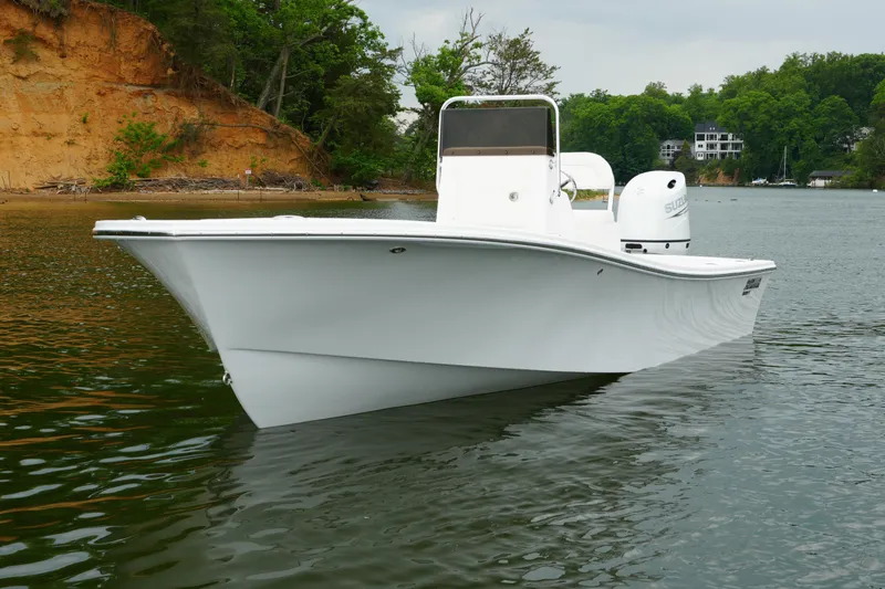 The Image of 2026 Privateer 2100 Roamer boat on calm water, surrounded by lush greenery. - 0