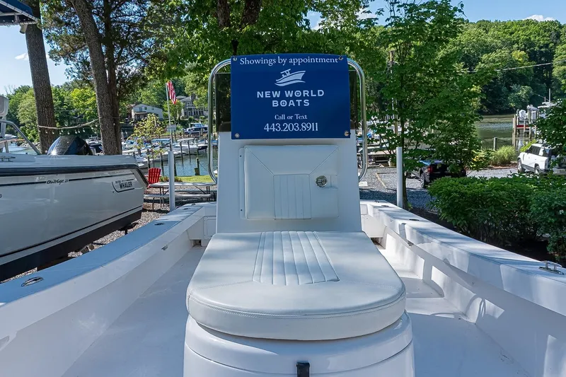 Slide: The Image of Privateer 2100 Roamer 2026 boat on display at New World Boats dealership. - 11