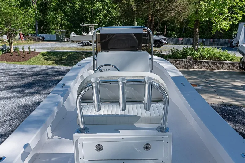 Slide: The Image of 2026 Privateer 2100 Roamer boat with sleek design, parked outdoors on a sunny day. - 6