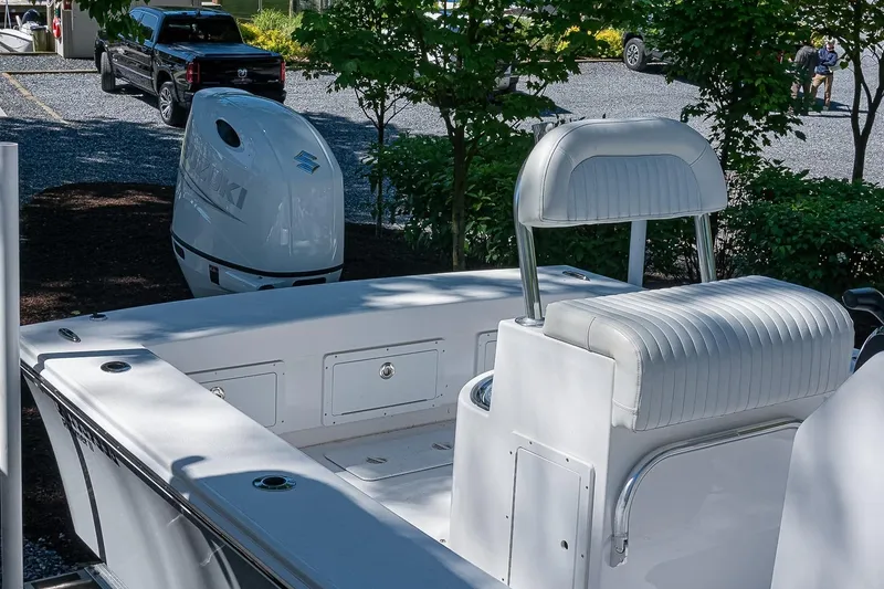 Slide: The Image of 2026 Privateer 2100 Roamer boat with Suzuki outboard motor, parked near trees. - 9