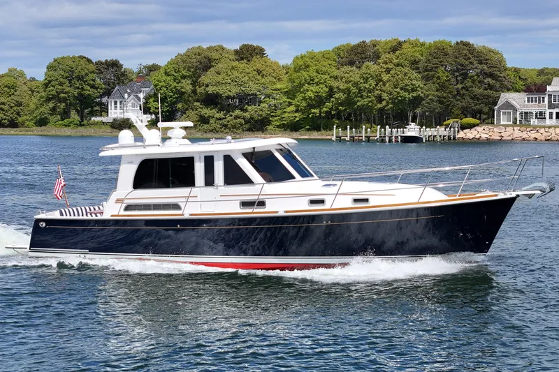 The Image of 2015 Sabre 42 Salon Express yacht cruising on a scenic waterway. - 0