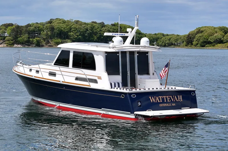 Slide: The Image of 2015 Sabre 42 Salon Express yacht on water, displaying "WATTEVAH" and American flag. - 13
