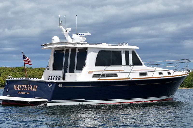 Slide: The Image of 2015 Sabre 42 Salon Express yacht on water, displaying American flag. - 14