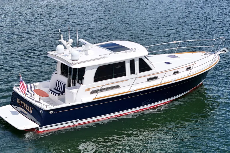 Slide: The Image of 2015 Sabre 42 Salon Express yacht on water, featuring sleek design and American flag. - 17