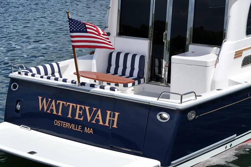 Slide: The Image of 2015 Sabre 42 Salon Express yacht with American flag, named "WATTEVAH," docked in Osterville, MA. - 18