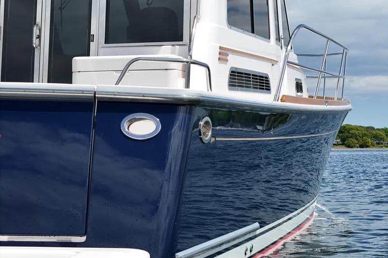 Slide: The Image of 2015 Sabre 42 Salon Express yacht on calm water, showcasing sleek design and blue hull. - 20