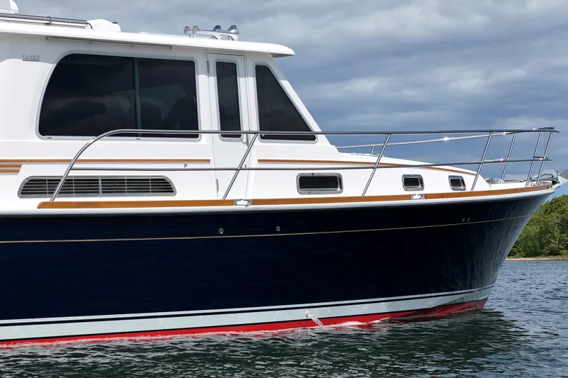 Slide: The Image of 2015 Sabre 42 Salon Express yacht on water, showcasing sleek design and elegant lines. - 21