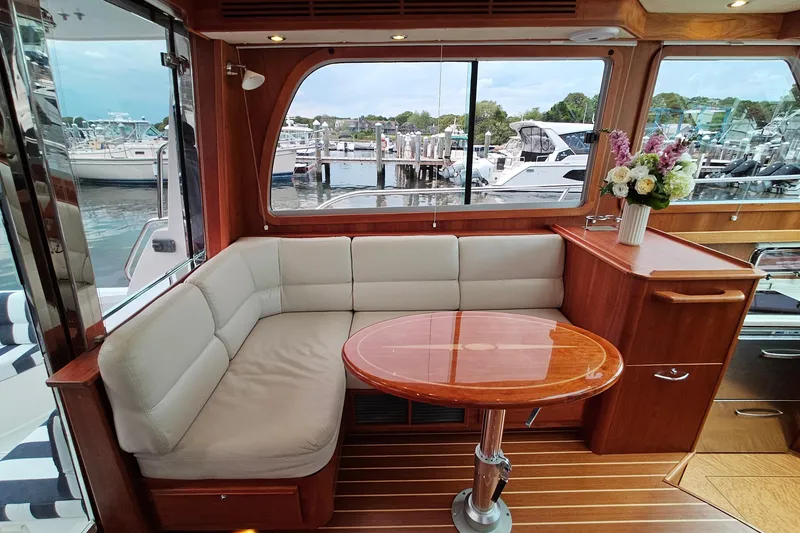 Slide: The Image of Interior of 2015 Sabre 42 Salon Express with elegant seating and wooden table. - 24