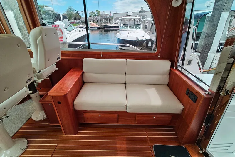Slide: The Image of Interior of 2015 Sabre 42 Salon Express with plush seating and wooden accents. - 26