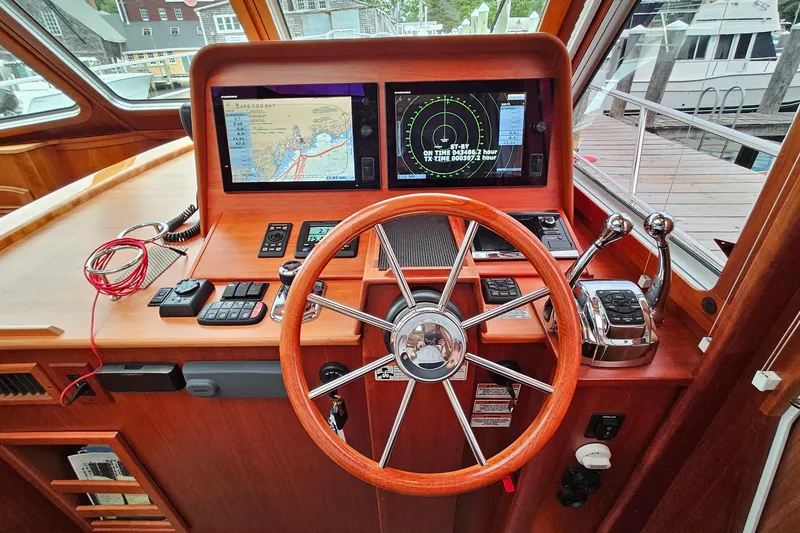 Slide: The Image of Helm of 2015 Sabre 42 Salon Express with navigation screens and wooden steering wheel. - 30