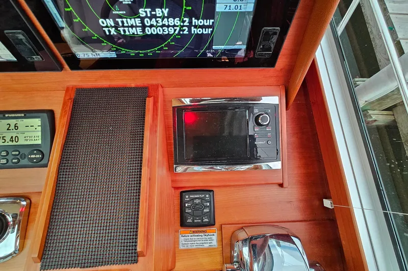 Slide: The Image of Control panel of a 2015 Sabre 42 Salon Express yacht with navigation instruments. - 33