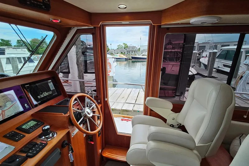 Slide: The Image of Interior of 2015 Sabre 42 Salon Express yacht with helm and marina view. - 36