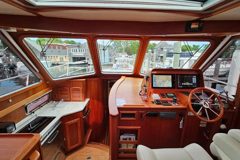 Slide: The Image of Interior view of 2015 Sabre 42 Salon Express yacht with navigation equipment and wooden finish. - 38