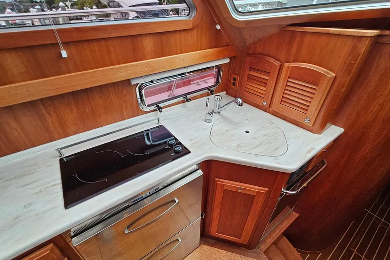Slide: The Image of Interior of 2015 Sabre 42 Salon Express yacht kitchen with stove and sink. - 42