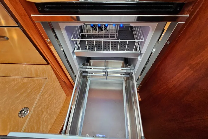 Slide: The Image of Open refrigerator drawer in 2015 Sabre 42 Salon Express yacht kitchen. - 46