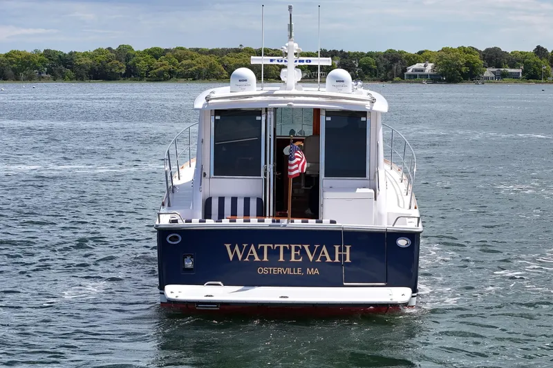 Slide: The Image of 2015 Sabre 42 Salon Express yacht on water, rear view with American flag. - 5