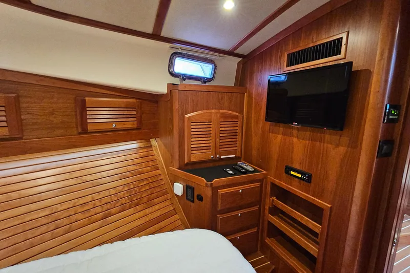 Slide: The Image of Luxurious wood interior of 2015 Sabre 42 Salon Express yacht cabin with TV and storage. - 52