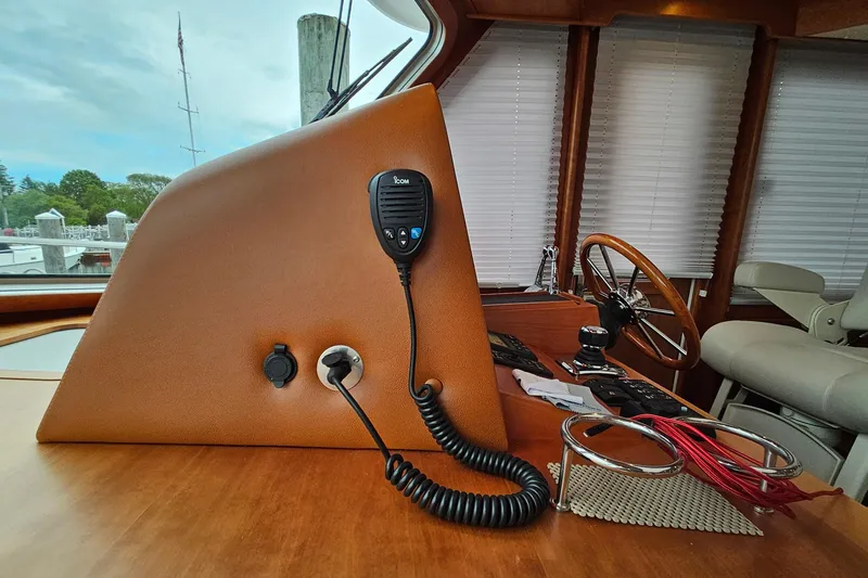 Slide: The Image of Helm station of 2015 Sabre 42 Salon Express with steering wheel and communication equipment. - 58