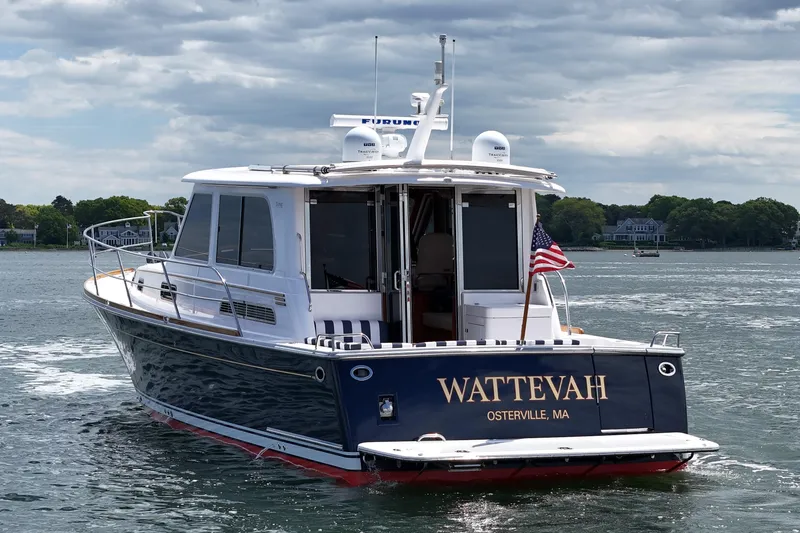 Slide: The Image of 2015 Sabre 42 Salon Express yacht on water, displaying "WATTEVAH" and American flag. - 6