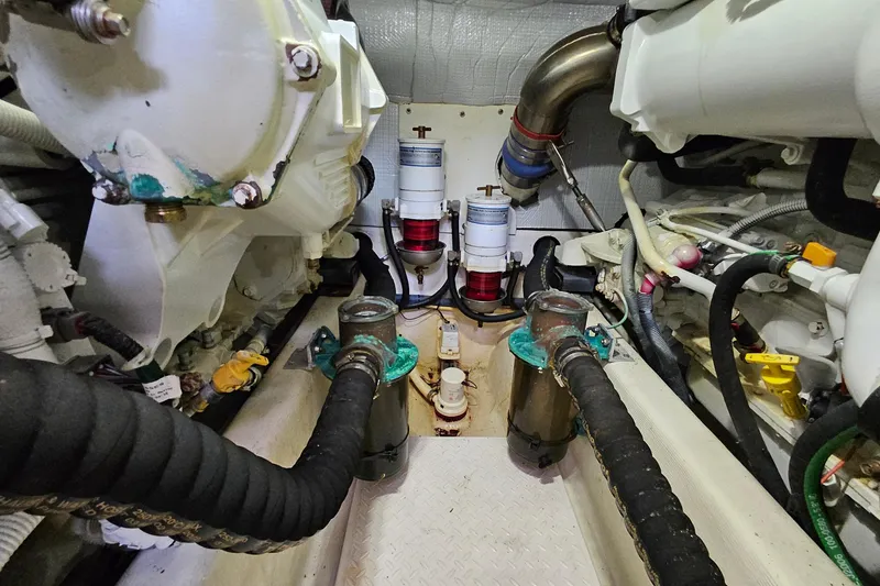 Slide: The Image of Engine room of 2015 Sabre 42 Salon Express with visible hoses and components. - 64