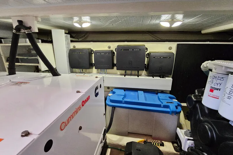 Slide: The Image of Engine room of 2015 Sabre 42 Salon Express with Cummins Onan generator and electrical components. - 67
