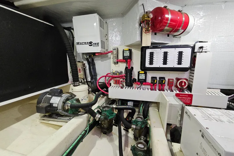 Slide: The Image of Engine room of 2015 Sabre 42 Salon Express with electrical systems and fire extinguisher. - 69