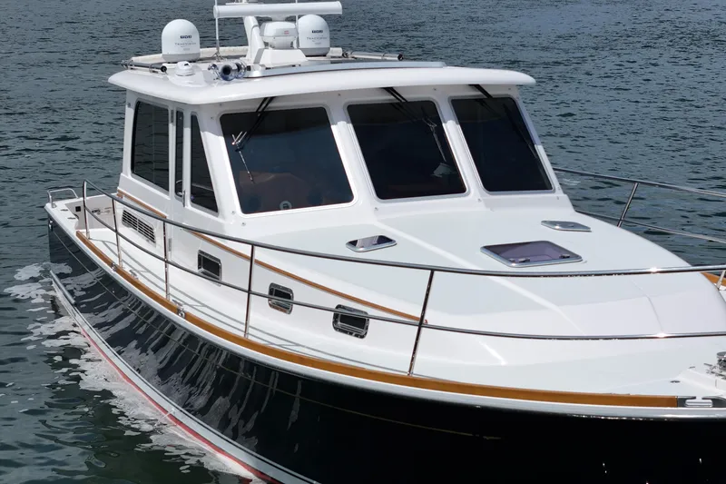 Slide: The Image of 2015 Sabre 42 Salon Express yacht cruising on calm waters. - 9