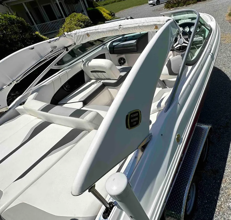 Slide: The Image of 2019 Regal 2000 ES Bowrider boat with white interior and sleek design. - 12