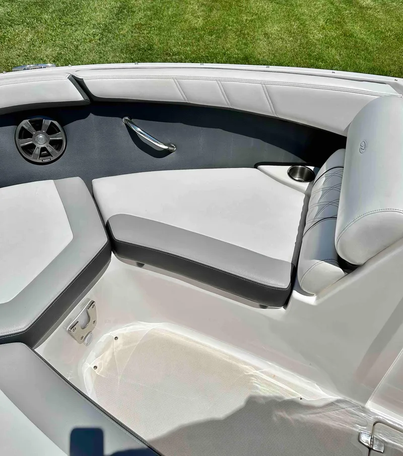 Slide: The Image of 2019 Regal 2000 ES Bowrider boat interior with cushioned seating and cup holder. - 16