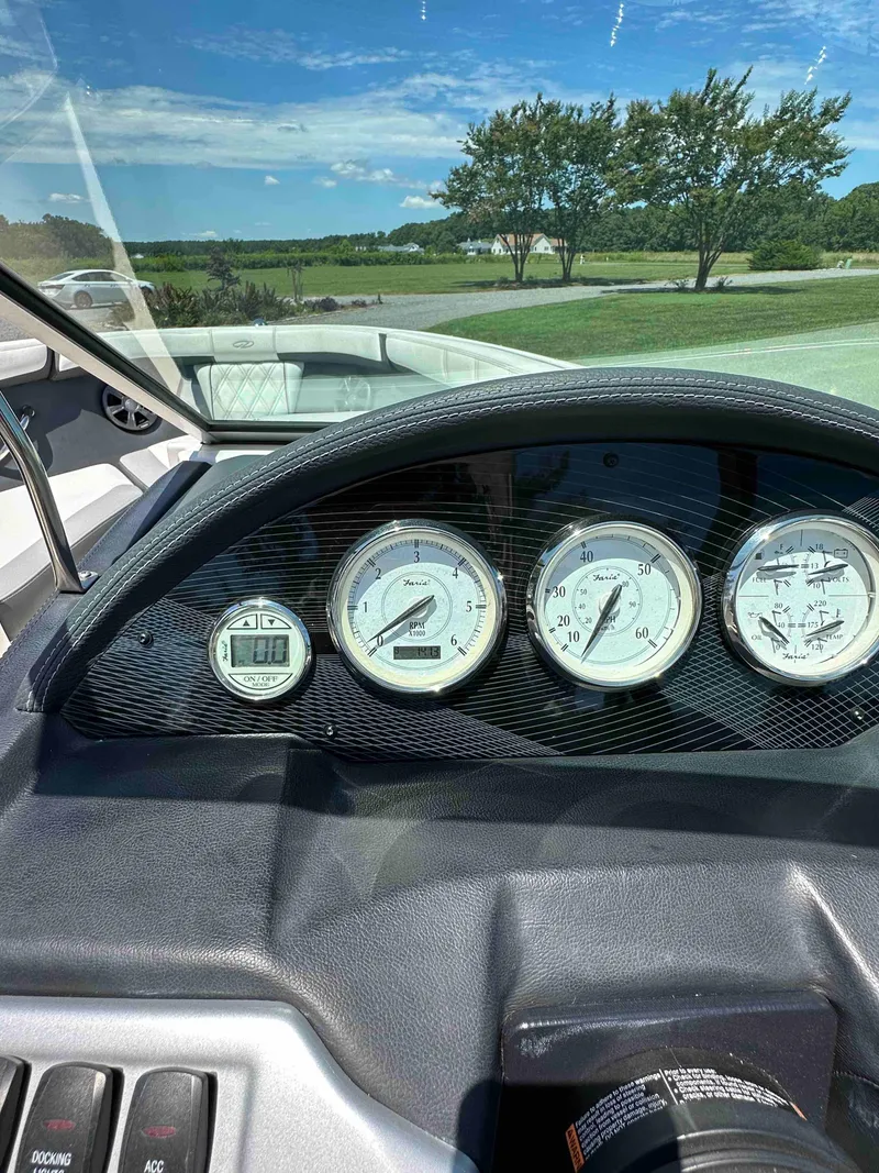 Slide: The Image of Dashboard of a 2019 Regal 2000 ES Bowrider boat with gauges and scenic view. - 18