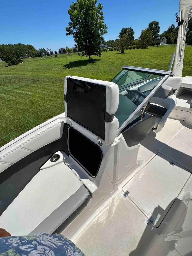 Slide: The Image of 2019 Regal 2000 ES Bowrider interior with seating and windshield, parked on grassy field. - 8
