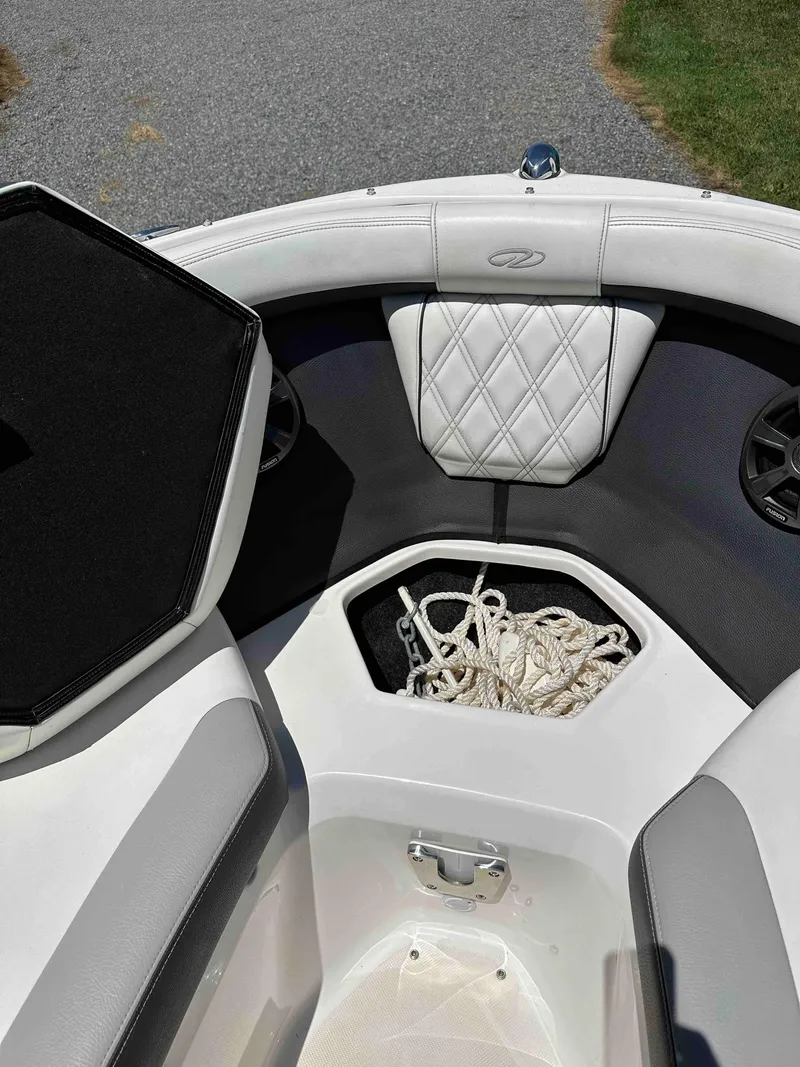 Slide: The Image of 2019 Regal 2000 ES Bowrider interior with rope storage and cushioned seating. - 9