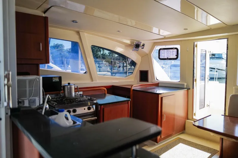 Slide: The Image of Interior of a 2012 Leopard 44 yacht kitchen with modern amenities and large windows. - 12