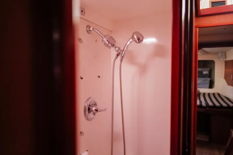 Slide: The Image of Shower area inside a 2012 Leopard 44 yacht, featuring modern fixtures and cozy cabin view. - 21