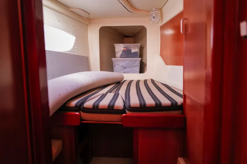 Slide: The Image of Interior cabin of a 2012 Leopard 44 yacht with striped bedding. - 22