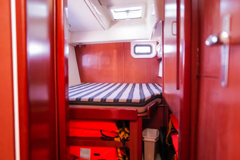 Slide: The Image of Cozy cabin interior of 2012 Leopard 44 yacht with striped bedding and wooden finish. - 26