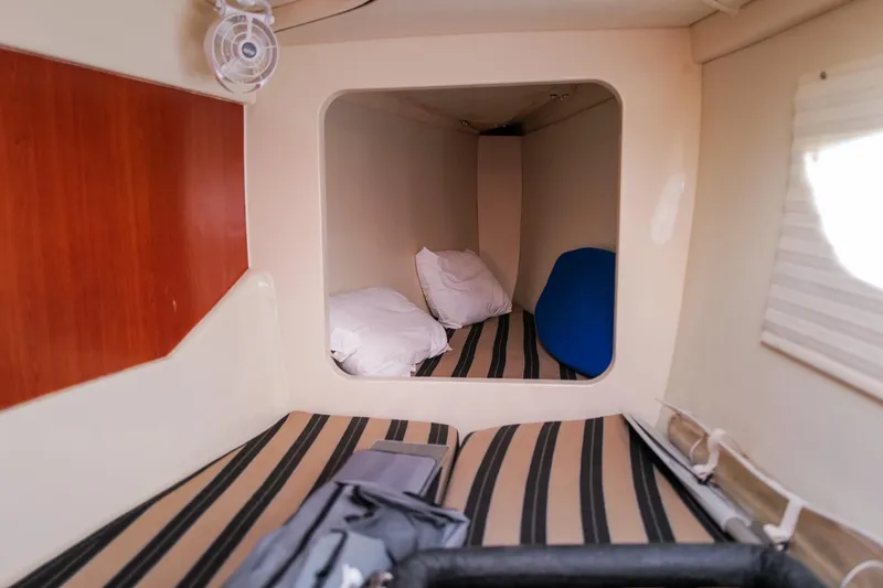 Slide: The Image of Cozy cabin interior of 2012 Leopard 44 yacht with striped bedding and pillows. - 30