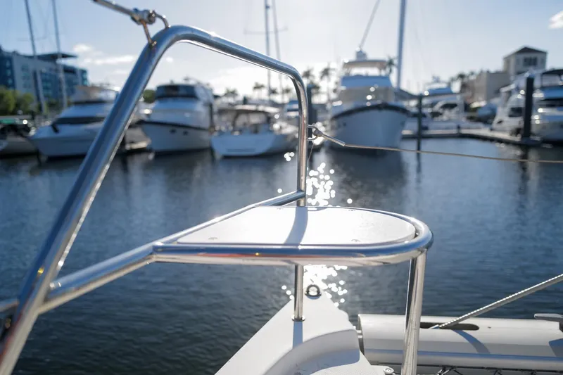 Slide: The Image of Bow of a 2012 Leopard 44 yacht in a marina, with boats in the background. - 34