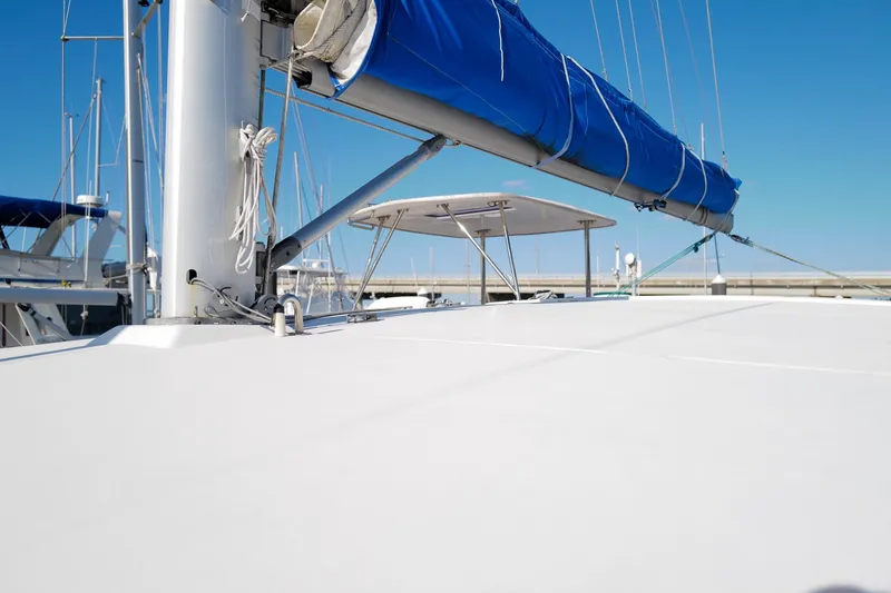 Slide: The Image of Sailboat deck view of 2012 Leopard 44 with blue sail cover under clear sky. - 35
