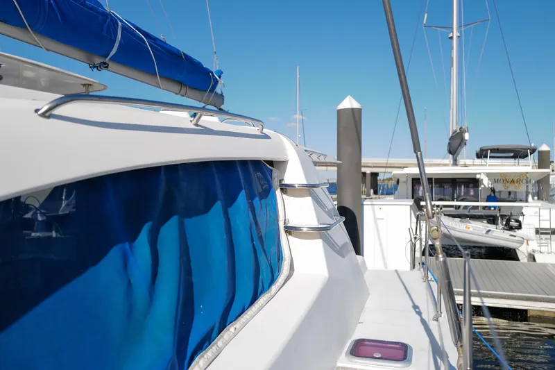 Slide: The Image of Leopard 44 catamaran docked at marina, blue sail cover, sunny day, 2012 model. - 36