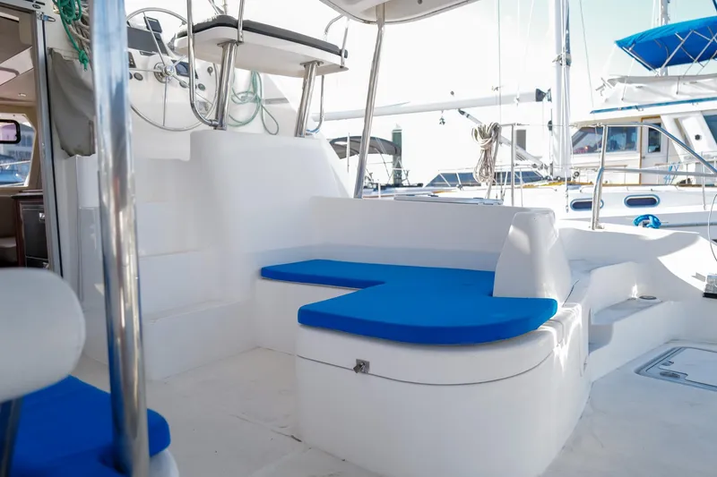 Slide: The Image of Spacious deck of 2012 Leopard 44 catamaran with blue cushioned seating and helm station. - 38