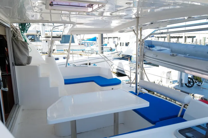 Slide: The Image of Leopard 44 catamaran deck with blue seating, docked at marina, 2012 model. - 4
