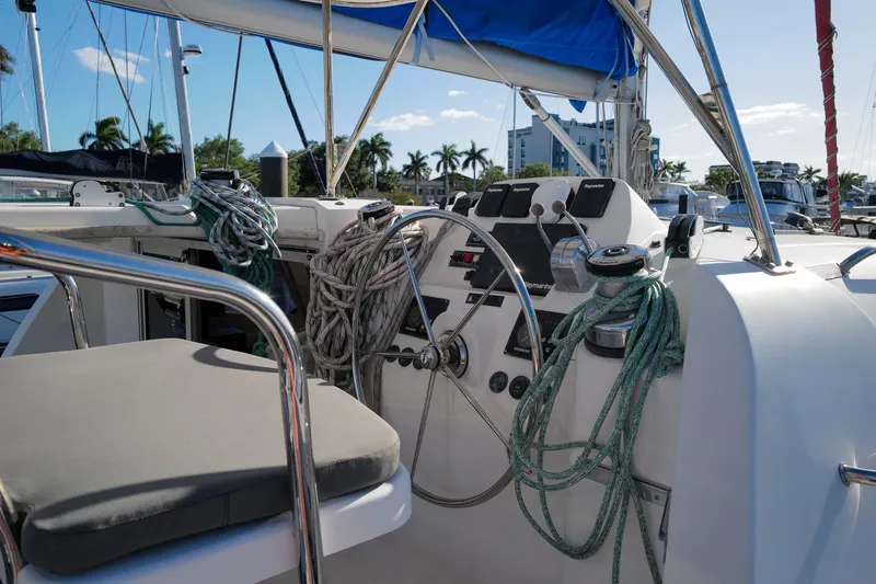Slide: The Image of Cockpit of 2012 Leopard 44 sailboat with ropes and steering wheel in marina setting. - 7