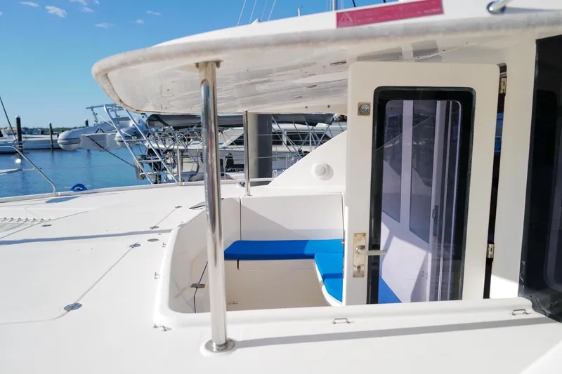 Slide: The Image of 2012 Leopard 44 catamaran with blue seating, docked at a marina under clear skies. - 8