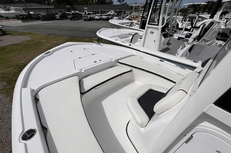 Slide: The Image of 2026 Tidewater 2210 Carolina Bay boat interior with cushioned seating and storage compartments. - 10